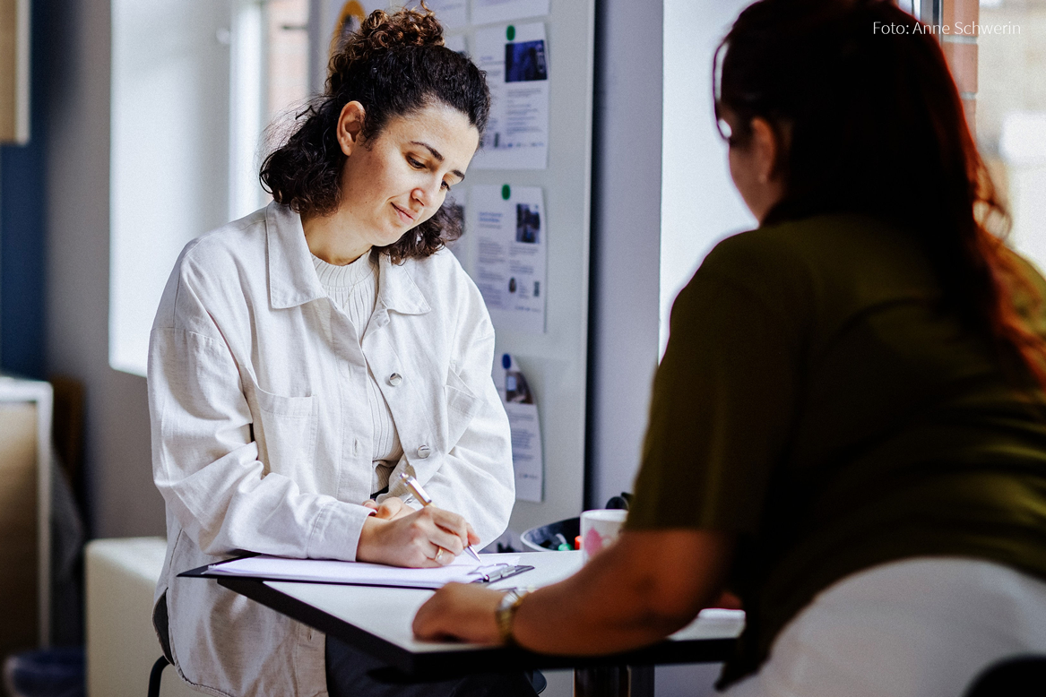 Two women are concentrating on a task